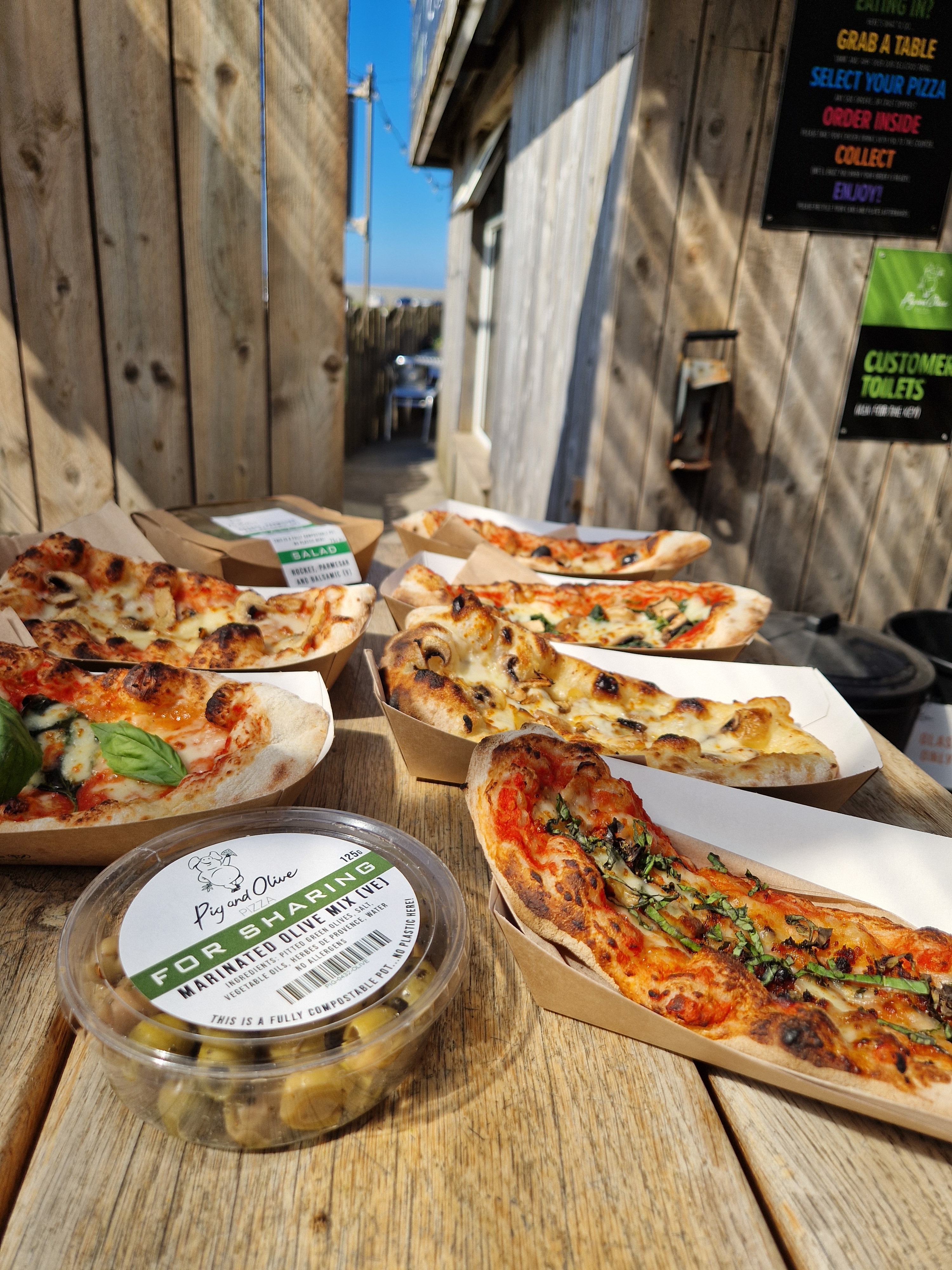 Pig and Olive Pizzetta selection with salad and olives